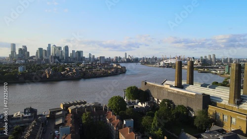 Thames river around Greenwich power plant, skyscrapers in background photo