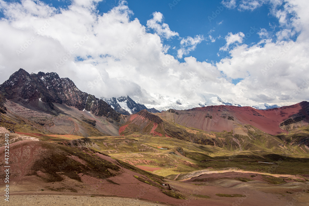 Colorful Rainbow Mountains against Blue Sky of Fluffy White Clouds in Peru