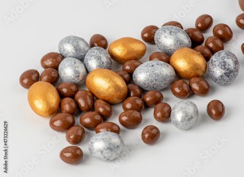 golden silver and chocolate eggs on a white background. Happy Easter concept