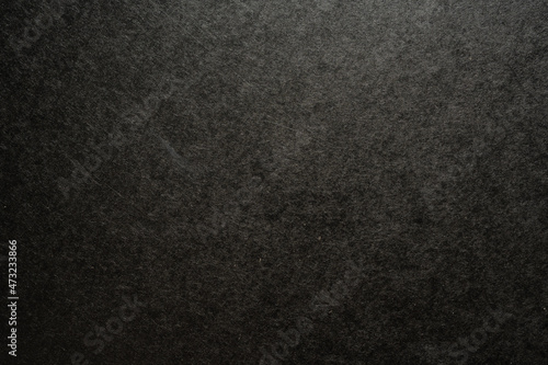 Black paper with uneven texture background