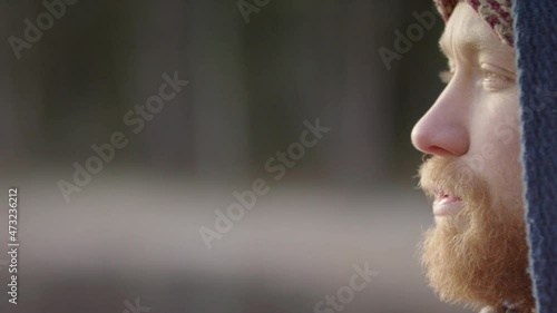 PAN REVEAL CU of a handsome bearded ice bather conscious breathing before going in photo