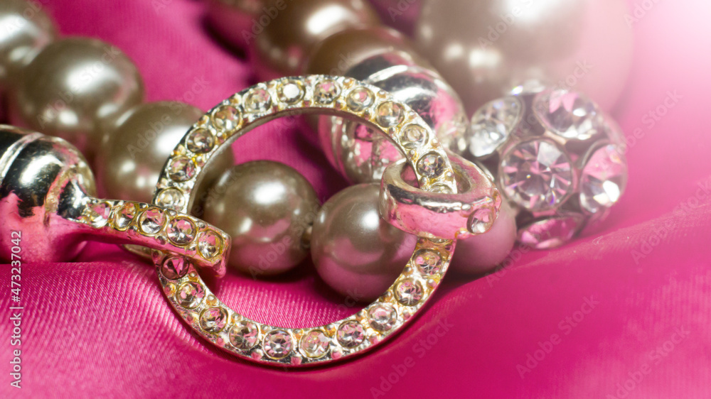 Bracelet made of beads and rhinestones on a pink background Bracelet made of beads and rhinestones on a pink background