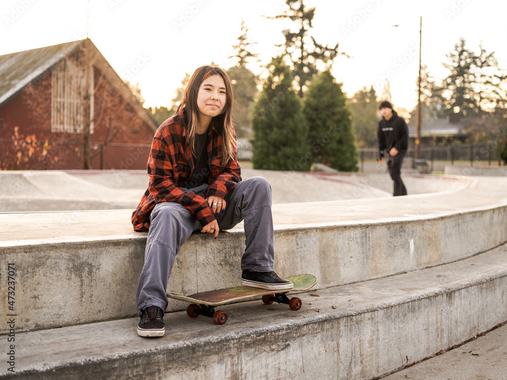 Young Indigenous nonbinary skater outdoors Stock Photo Adobe Stock