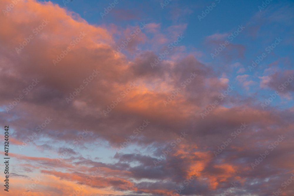 different colored clouds by sunset