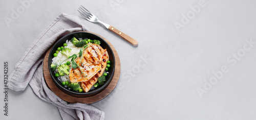 Grilled chicken with green vegetables and rice.