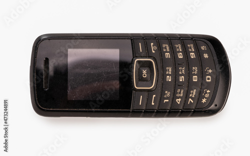 Black cell phone old fashion with English keypad and Thai language.