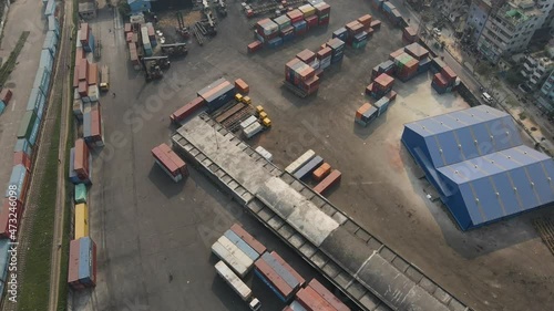 Aerial: inland shipping container terminal with warehouse inside city- drone flight shot photo