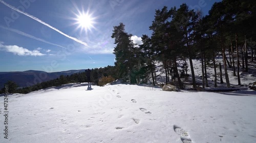 Man contemplating the mountainous landscape from the top of a snowy hill. Guadarrama Madrid. photo