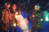 group of friends with snowman sparklers party, christmas night and happy new year