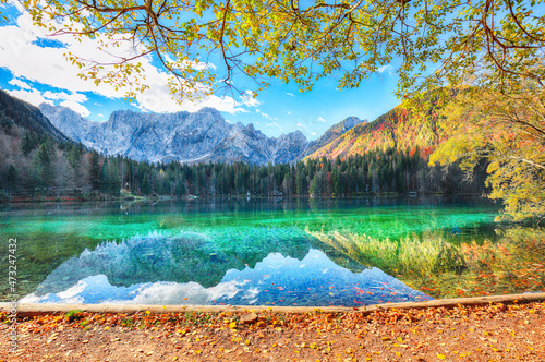 Astonishing view of Fusine lake with Mangart peak on background photo