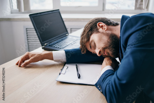 manager sitting at a desk in front of a laptop finance network professional