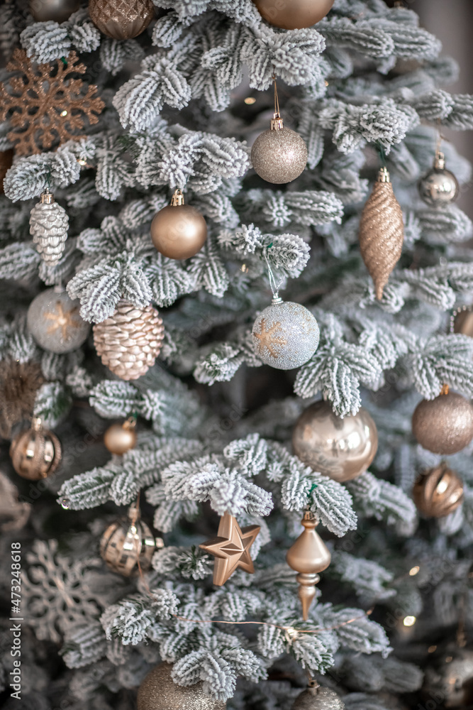 Close-up of a festively decorated outdoor Christmas tree with balls on a blurred sparkling fairy background. Defocused garland lights, bokeh effect. Close-up of a festively decorated outdoor Christmas tree with balls on a blurred sparkling fairy background. Defocused garland lights, bokeh effect.