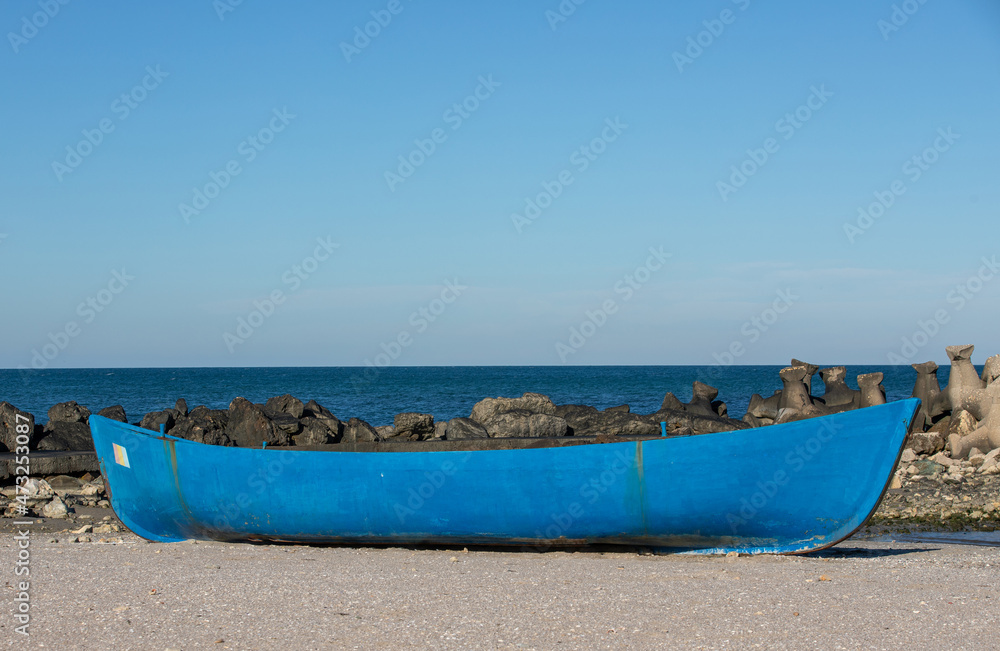 an old boat on the sea shore
