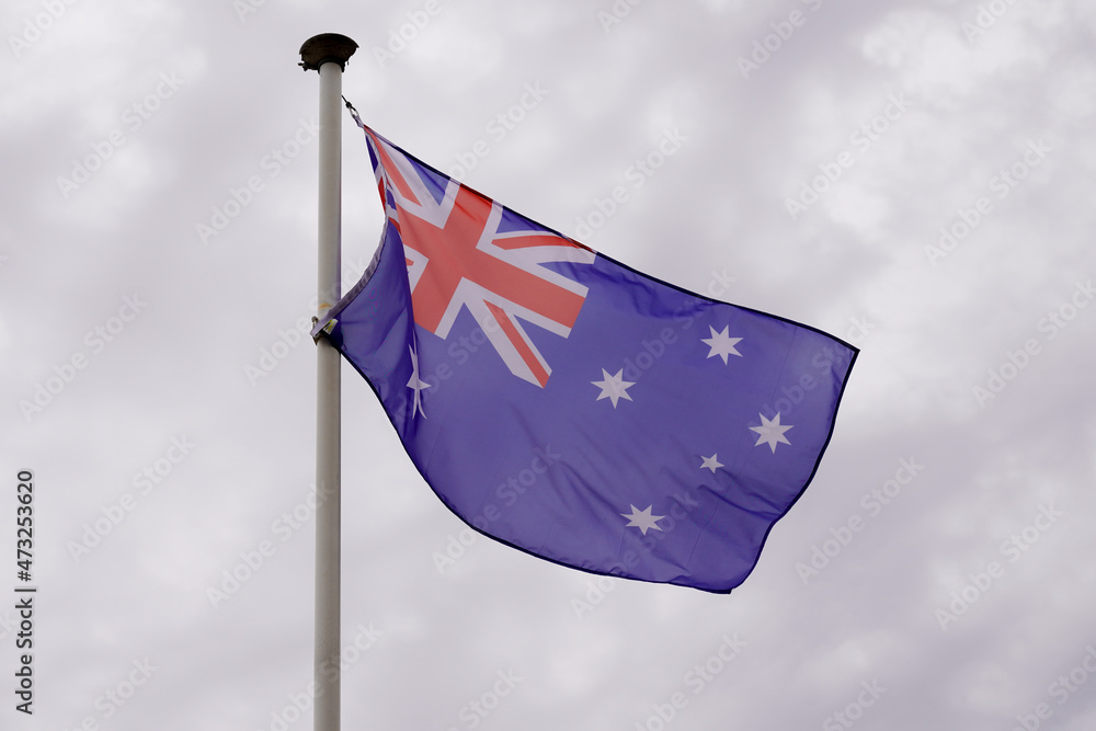 australian red blue white flag in cloud sky in Australia