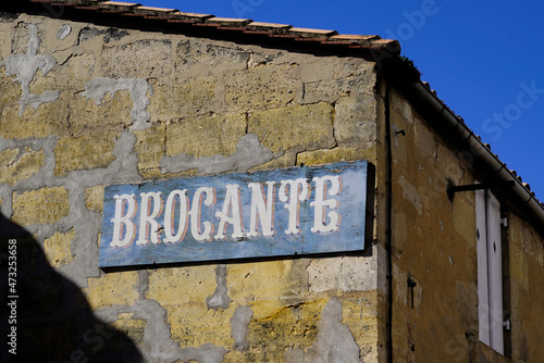 old blue panel in facade street shop sign text in french brocante translation means in english antiquities store photo