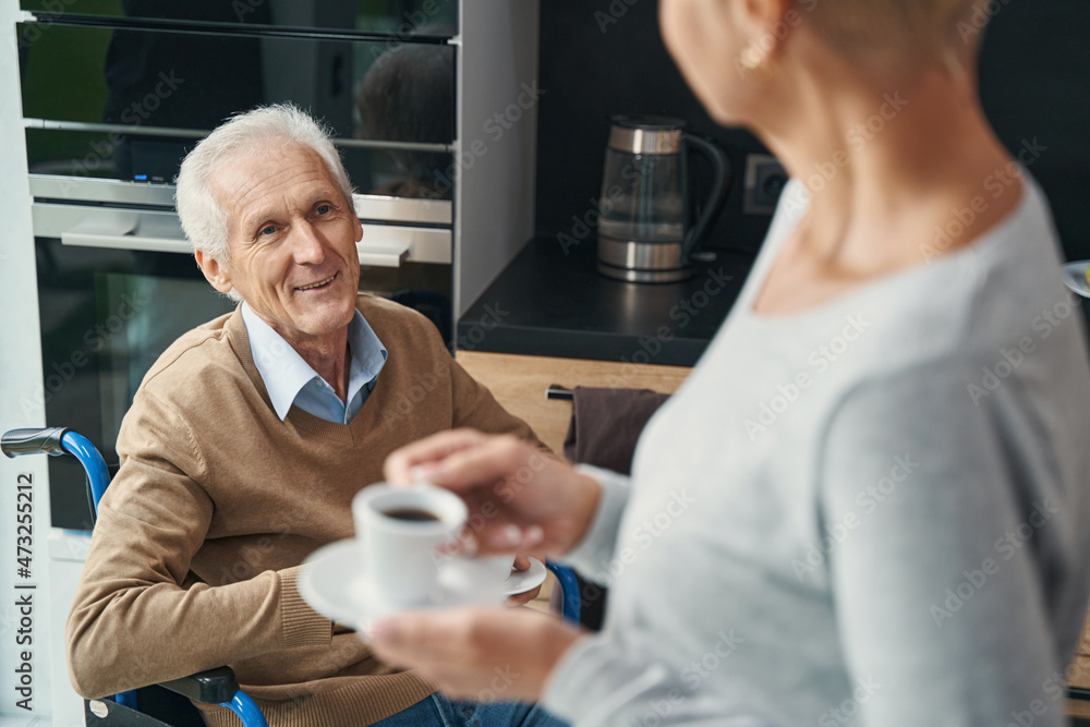 Close up of happy wheelchair user looking at his wife Close up of happy wheelchair user looking at his wife