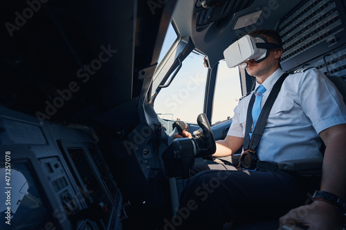 Slika na platnu Pilot in cockpit sitting with VR headset