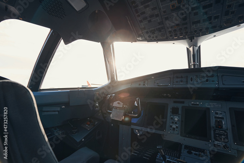 Empty airplane cockpit with sun shining through window