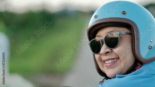 woman wearing a helmet before riding a motorcycle © sumet