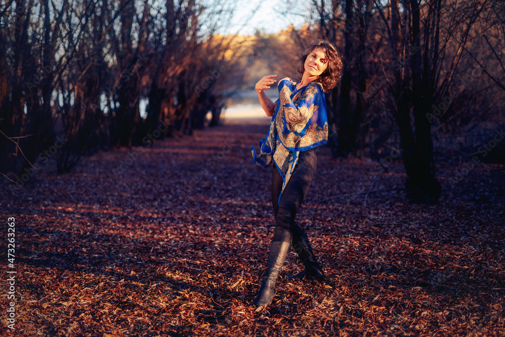 Beautiful woman dancing in nature at sunset. Beautiful woman dancing in nature at sunset.