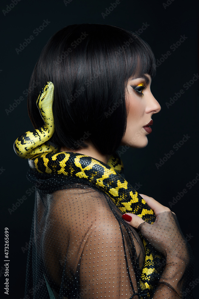 Beauty woman short haircut python yellow snake on her neck. A yellow ...