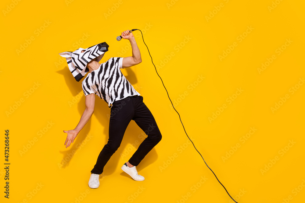 Full length photo of freak famous singer in zebra mask sing mic sound isolated over bright yellow color background - obrazy, fototapety, plakaty 