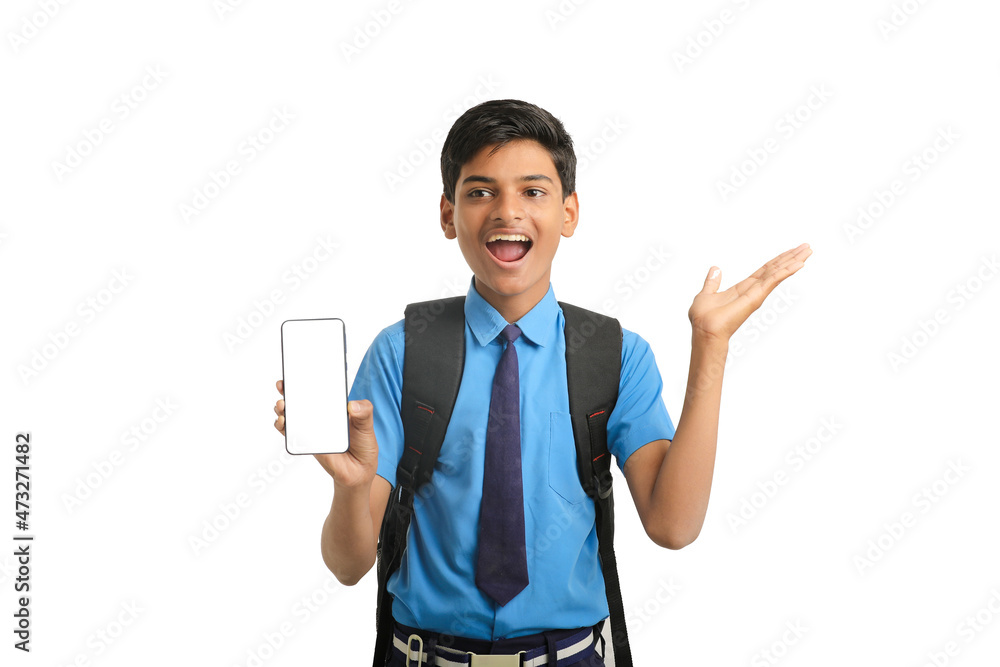 technology concept: Cute indian little school boy showing smartphone technology concept: Cute indian little school boy showing smartphone