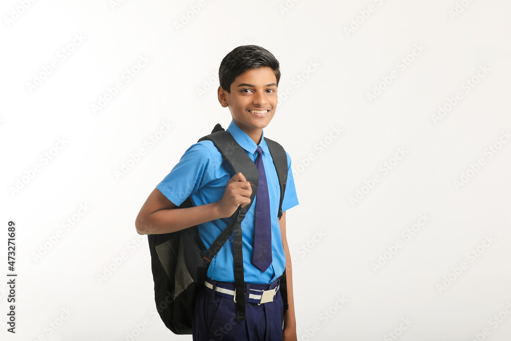 Indian school boy standing on white background. Indian school boy standing on white background.