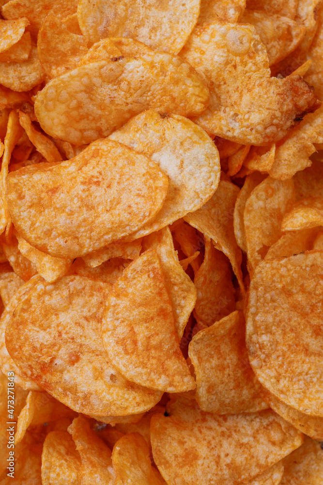 Potato chips or crisps . Close-up of potato chips or crisps. Food background. Potato chips or crisps . Close-up of potato chips or crisps. Food background.