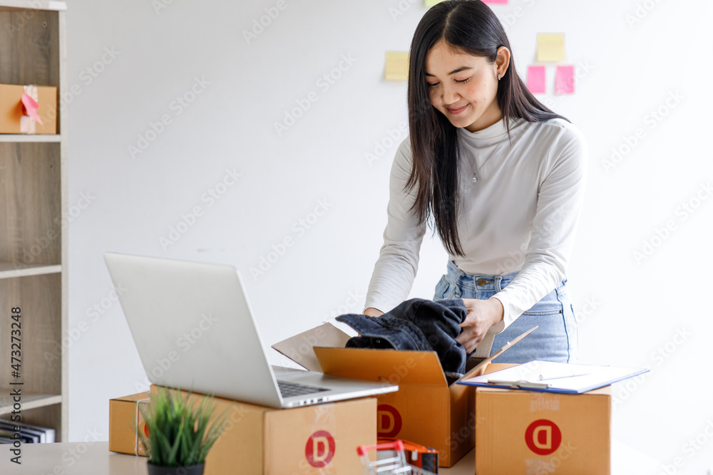 Portrait of Starting small businesses SME owners female entrepreneurs working on receipt box and check online orders to prepare to pack the boxes, sell to customers, sme business ideas online. Portrait of Starting small businesses SME owners female entrepreneurs working on receipt box and check online orders to prepare to pack the boxes, sell to customers, sme business ideas online.