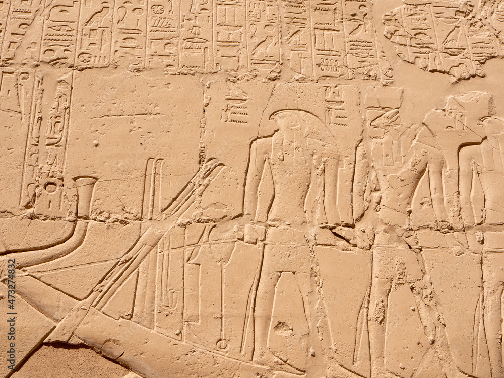 Egyptian hieroglyphs and ancient drawings in the Karnak Temple. The image of the Egyptian god Horus, in the guise of a man with the head of a falcon. Luxor, Egypt. Egyptian hieroglyphs and ancient drawings in the Karnak Temple. The image of the Egyptian god Horus, in the guise of a man with the head of a falcon. Luxor, Egypt.