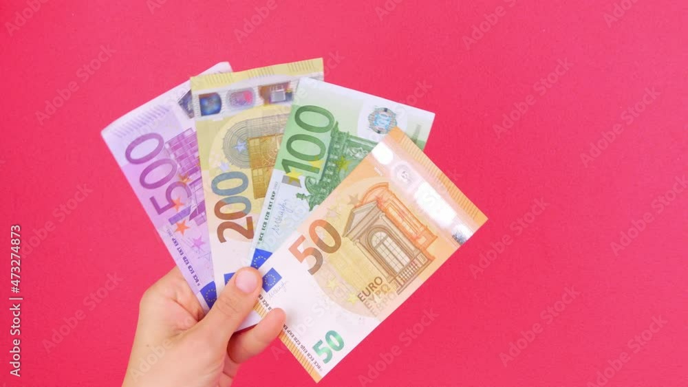Hand in holds 50, 100, 200 and 500 EURO money bill on pink color background. Counting cash european banknotes. Earning saving Eu currency exchange Wealth concept. Online casino winner business trading Hand in holds 50, 100, 200 and 500 EURO money bill on pink color background. Counting cash european banknotes. Earning saving Eu currency exchange Wealth concept. Online casino winner business trading