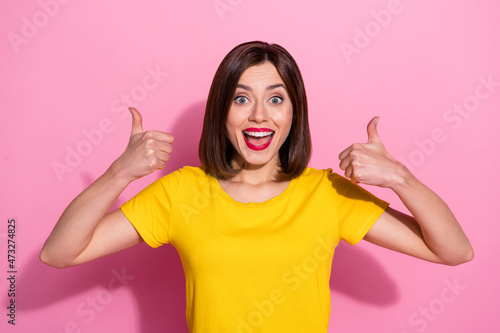 Portrait of attractive cheerful girl showing two double thumbup perfect isolated over pink pastel color background