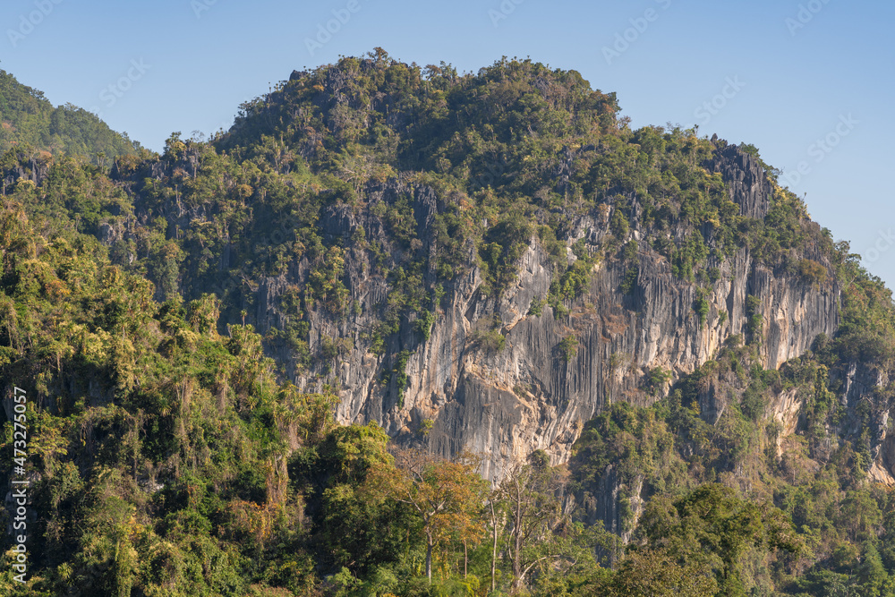Scenic landscape view of limestone mountain with cliff amid tropical forest in beautiful Chiang Dao countryside, Chiang Mai, Thailand