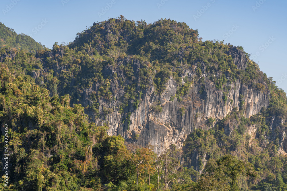 Scenic landscape view of limestone mountain with cliff amid tropical forest in beautiful Chiang Dao countryside, Chiang Mai, Thailand Scenic landscape view of limestone mountain with cliff amid tropical forest in beautiful Chiang Dao countryside, Chiang Mai, Thailand