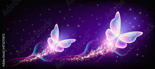 Flying delightful butterflies with sparkle and blazing trail flying in night sky among shiny glowing stars in cosmic space. Animal protection day concept.