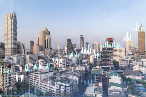 Financial stock chart hologram over panorama city view of Bangkok  business center in Southeast Asia. The concept of international transactions. Double exposure.