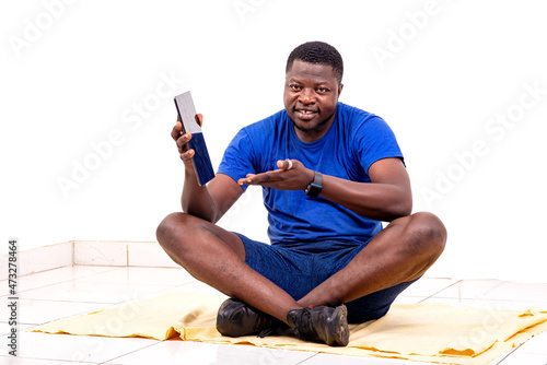 young sporty man sitting showing the screen of a digital tablet smiling.