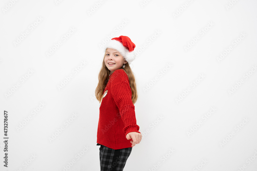 beautiful young girl in christmas outfit is posing in front of white background and is happy beautiful young girl in christmas outfit is posing in front of white background and is happy