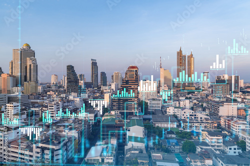 Glowing FOREX graph hologram  aerial panoramic cityscape of Bangkok at sunset. Stock and bond trading in Southeast Asia. The concept of fund management. Double exposure.