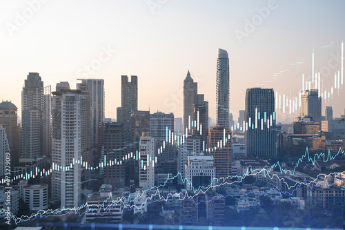 Market behavior graph hologram, sunset panoramic city view of Bangkok, popular location to achieve financial degree in Southeast Asia. The concept of financial data analysis. Double exposure. © VideoFlow