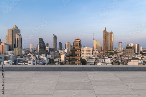 Panoramic Bangkok skyline view, concrete observatory deck on rooftop, sunset. Luxury Asian corporate and residential lifestyle. Financial city downtown, real estate. Product display mockup empty roof © VideoFlow