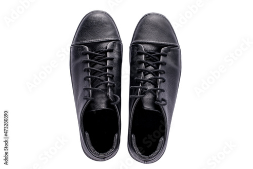 A pair of new black mens classic sneakers on a white isolated background.