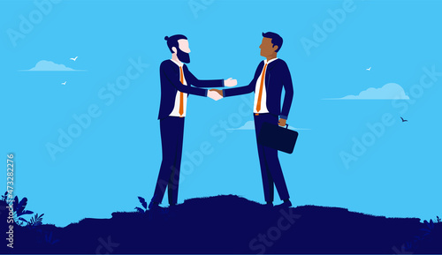 Businessmen handshake - Two people of different ethnicity shaking hands over deal and agreement. Flat design with blue background vector illustration