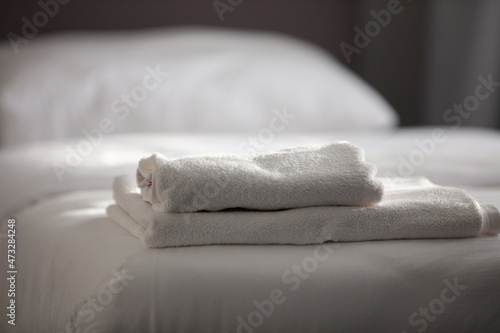 White clean towels stacked on the hotel bed. High quality photo © ercan senkaya