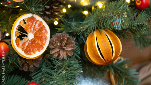 Christmas tree decorated with natural materials - slices of dried orange.