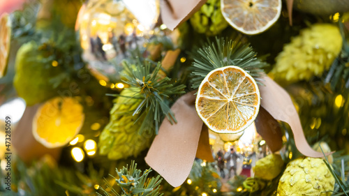 Fotografi Christmas tree decorated with natural materials - slices of dried orange