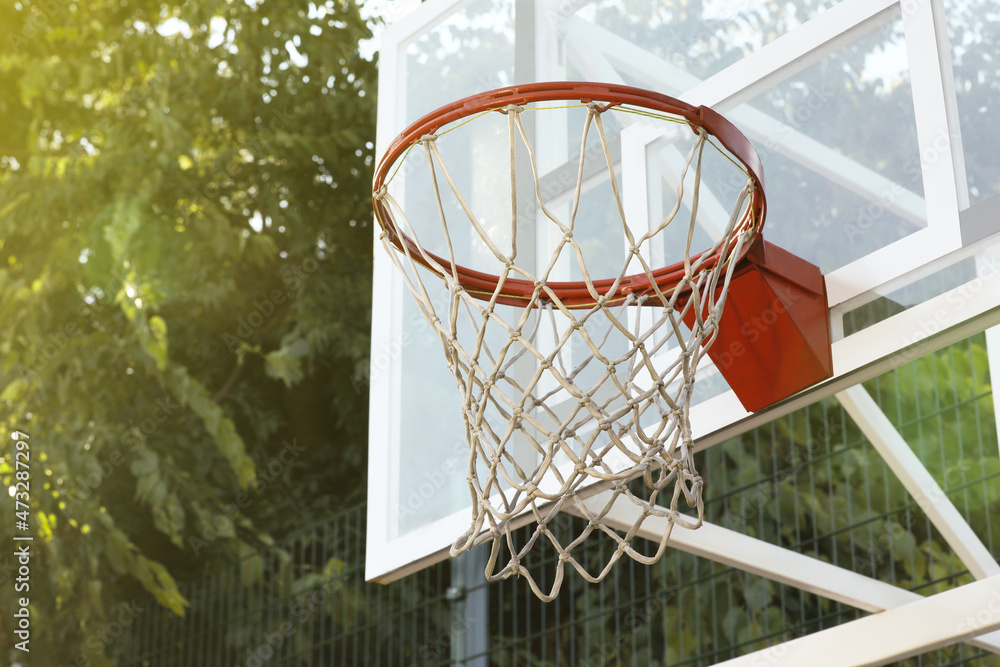 Basketball hoop with net outdoors, space for text Basketball hoop with net outdoors, space for text