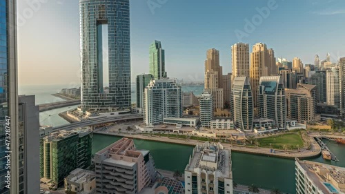 Panorama showing Dubai Marina skyscrapers and JBR district with luxury buildings and resorts aerial timelapse