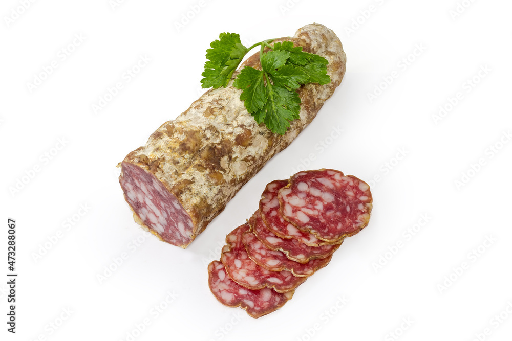 Partly sliced salami with parsley twig on a white background Partly sliced salami with parsley twig on a white background